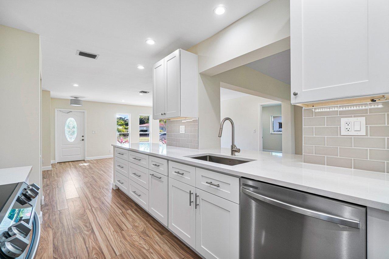 6359 Winding Brook Way Delray Beach, FL 33484 - Photo 3 of 24 a kitchen with sink and mirror
