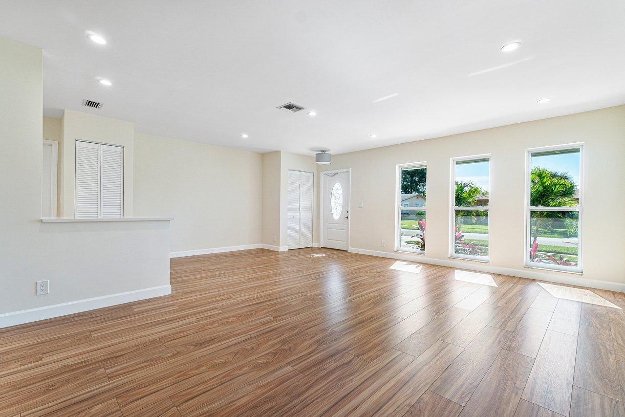 6359 Winding Brook Way Delray Beach, FL 33484 - Photo 4 of 24 a view of an empty room with wooden floor and a window