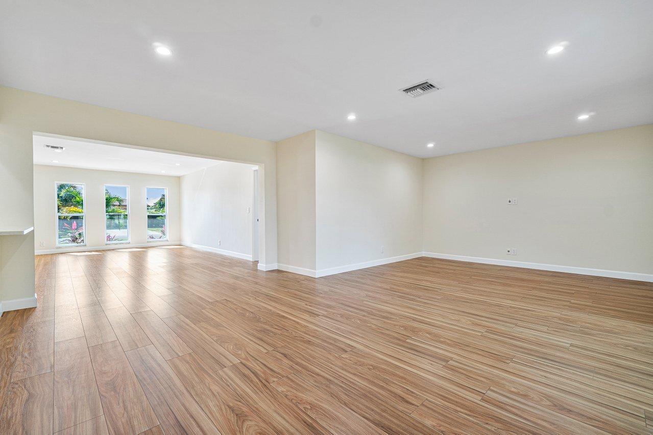 6359 Winding Brook Way Delray Beach, FL 33484 - Photo 9 of 24 a view of an empty room with wooden floor and a window