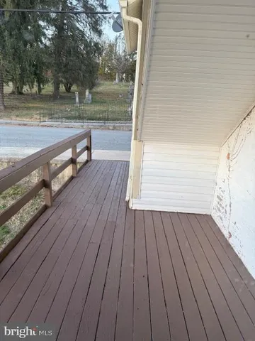 a view of a balcony with wooden floor