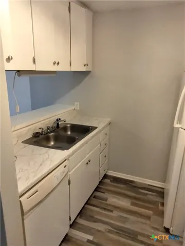 a kitchen with a sink and cabinets