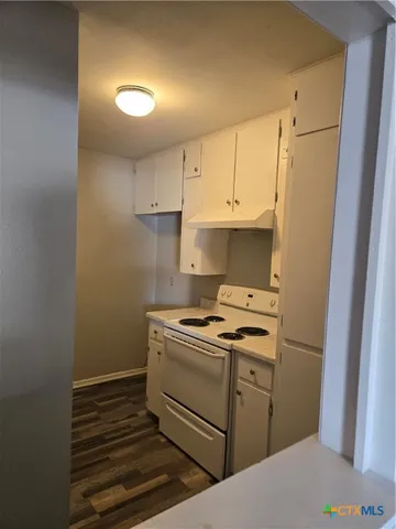 a kitchen with a stove and a refrigerator