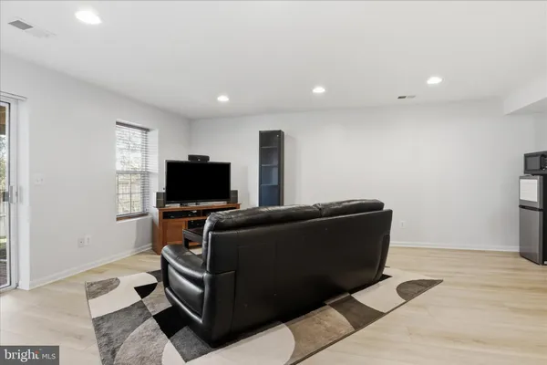 a view of a workspace with furniture and a flat screen tv