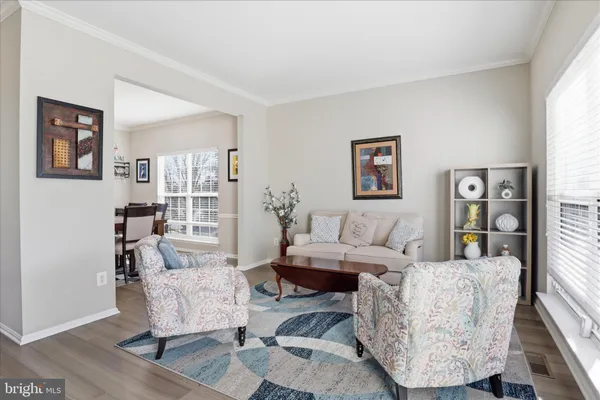 a view of a dining room with furniture window and wooden floor