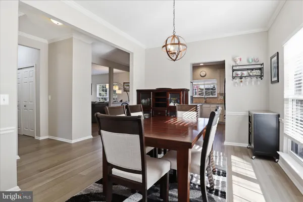 a kitchen with stainless steel appliances granite countertop a refrigerator a sink a stove a microwave and island with wooden floor