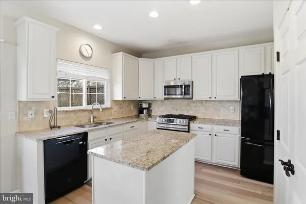 a kitchen with a stove a sink and a refrigerator