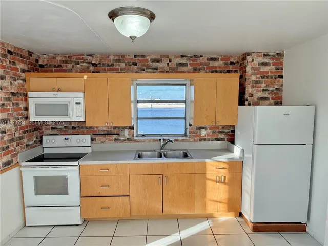 a kitchen with cabinets stainless steel appliances and a counter space