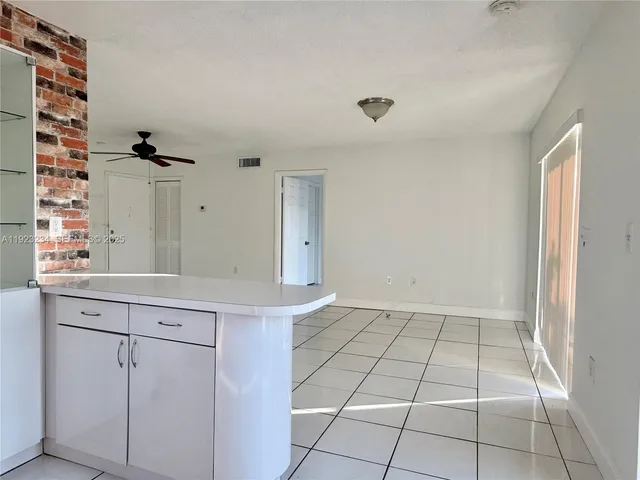 a view of a kitchen with a sink and cabinets