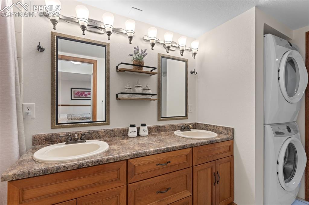 1851 Buttercup Road Elizabeth, CO 80107 - Photo 27 of 47 a bathroom with a granite countertop sink and a mirror
