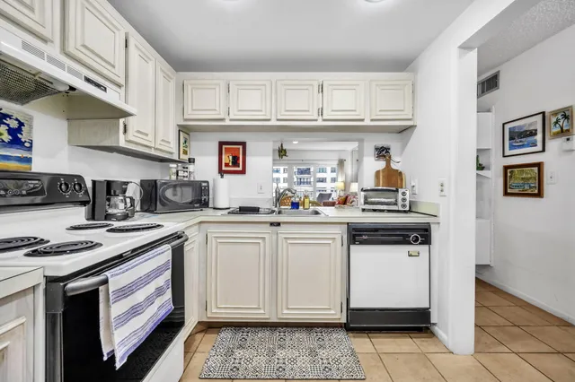 a kitchen with stainless steel appliances granite countertop a stove and cabinets