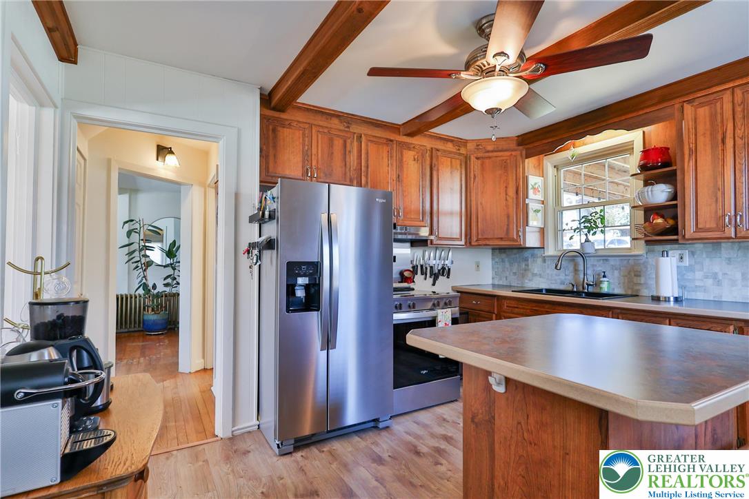 851 Media Street Bethlehem, PA 18017 - Photo 12 of 22 a kitchen with stainless steel appliances granite countertop a refrigerator a sink dishwasher a stove and a dining table with wooden floor
