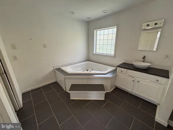 a bathroom with a sink toilet and window