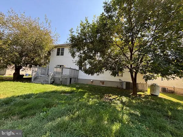 a view of backyard of house with green space