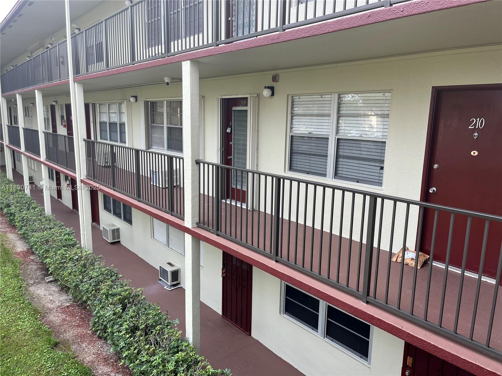 150 Southwest 134th Way, Unit 209R Pembroke Pines, FL 33027 - Photo 12 of 12 a view of a house with wooden fence