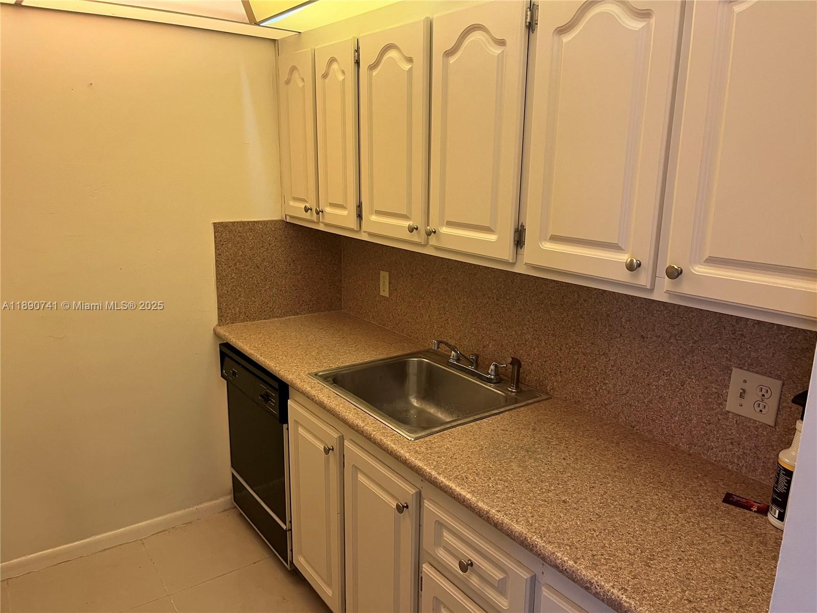 150 Southwest 134th Way, Unit 209R Pembroke Pines, FL 33027 - Photo 8 of 12 a kitchen with a sink and cabinets