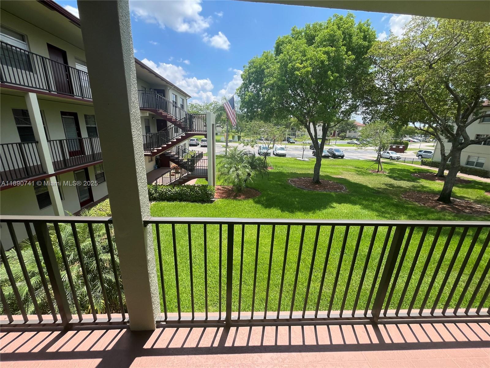 150 Southwest 134th Way, Unit 209R Pembroke Pines, FL 33027 - Photo 9 of 12 a view of a porch with a yard