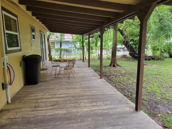 a view of a patio with table and chairs