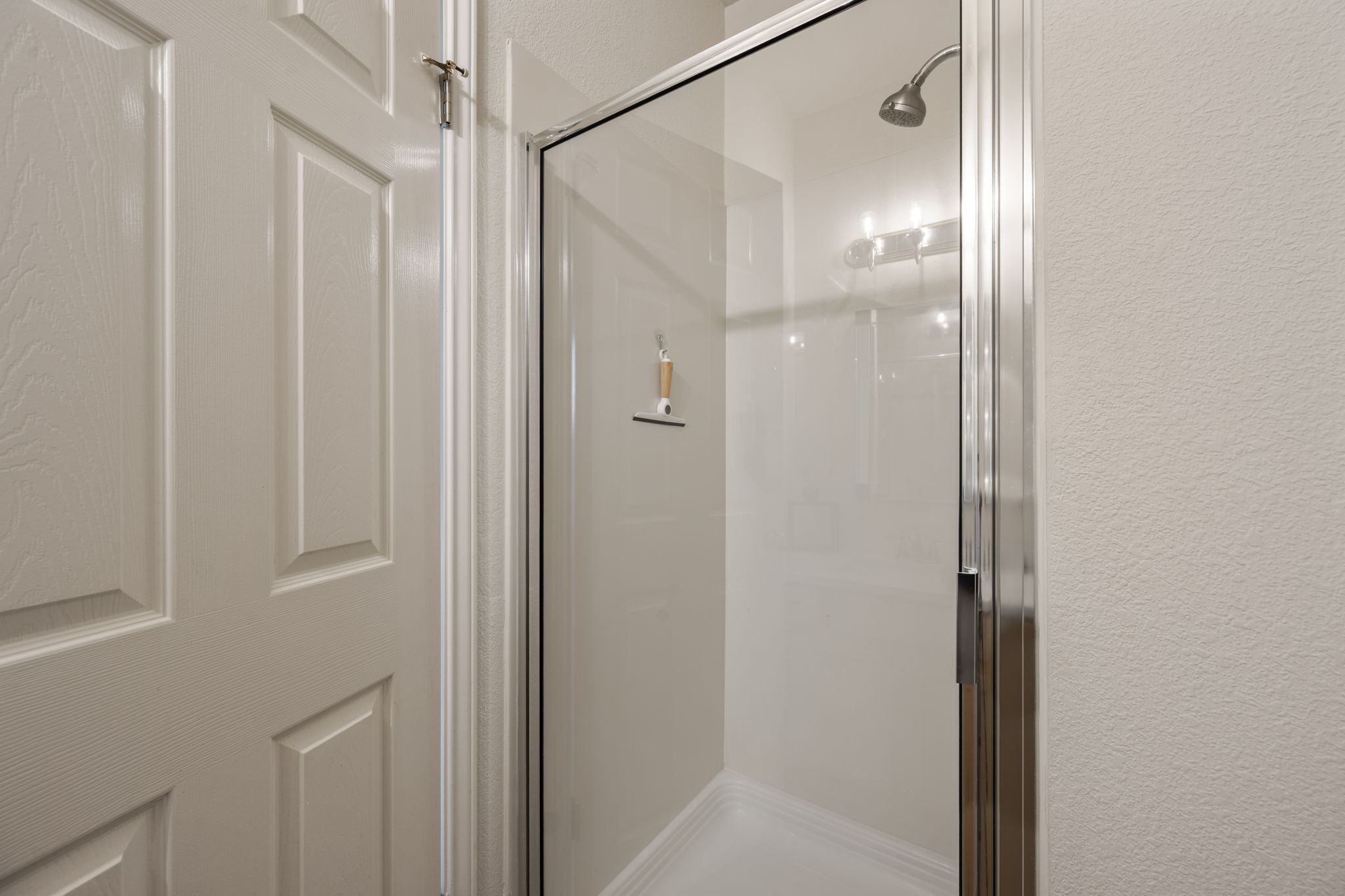 12401 Los Indios Trail, Unit 32 Austin, TX 78729 - Photo 25 of 39 A glass-enclosed shower stall with a sleek showerhead offers a refreshing bathing experience.
