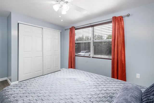 a bedroom with a large bed and a window