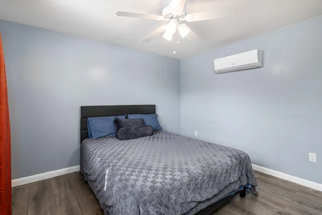 a bedroom with a large bed and a chandelier