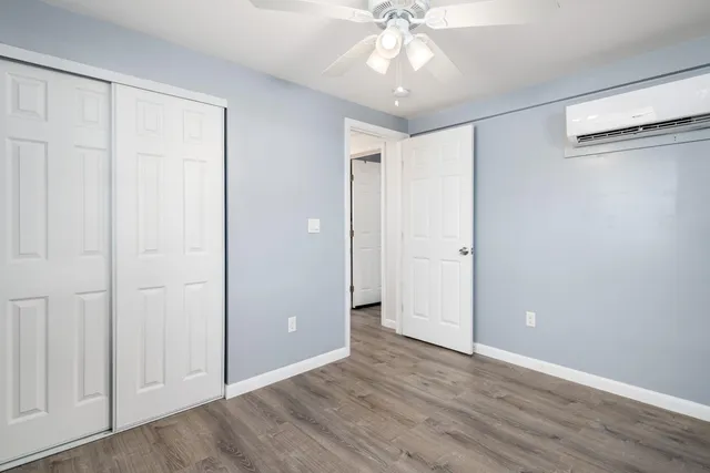 a view of an empty room with wooden floor