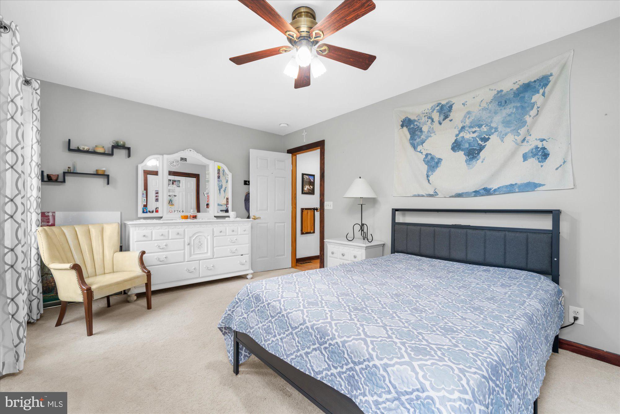 28 Highview Lane Mertztown, PA 19539 - Photo 20 of 57 a bedroom with a large bed a lamp and a chandelier