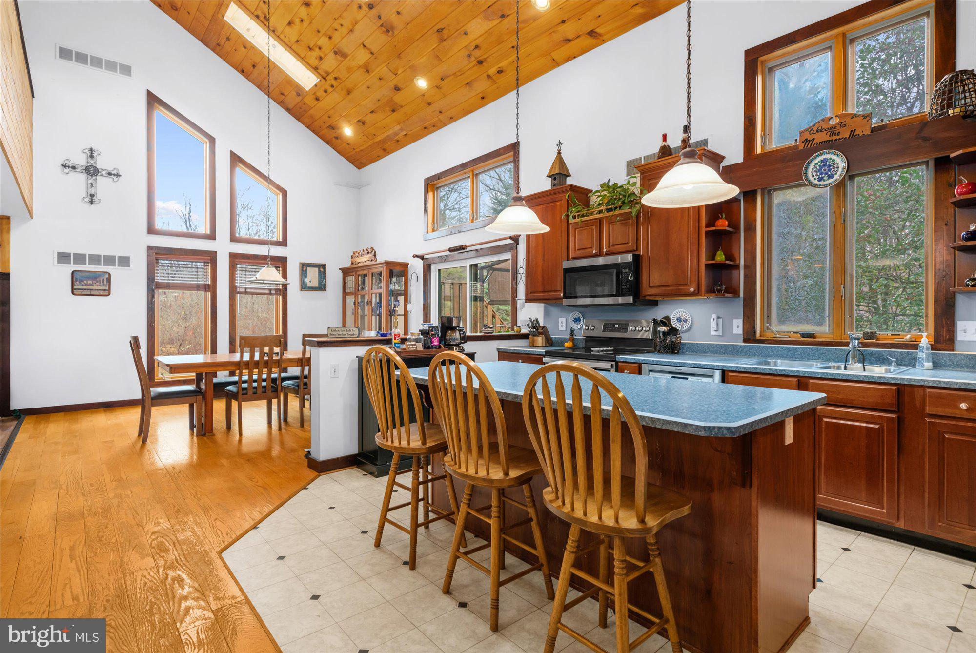 28 Highview Lane Mertztown, PA 19539 - Photo 6 of 57 a view of a kitchen with a dining table chairs and flat screen tv