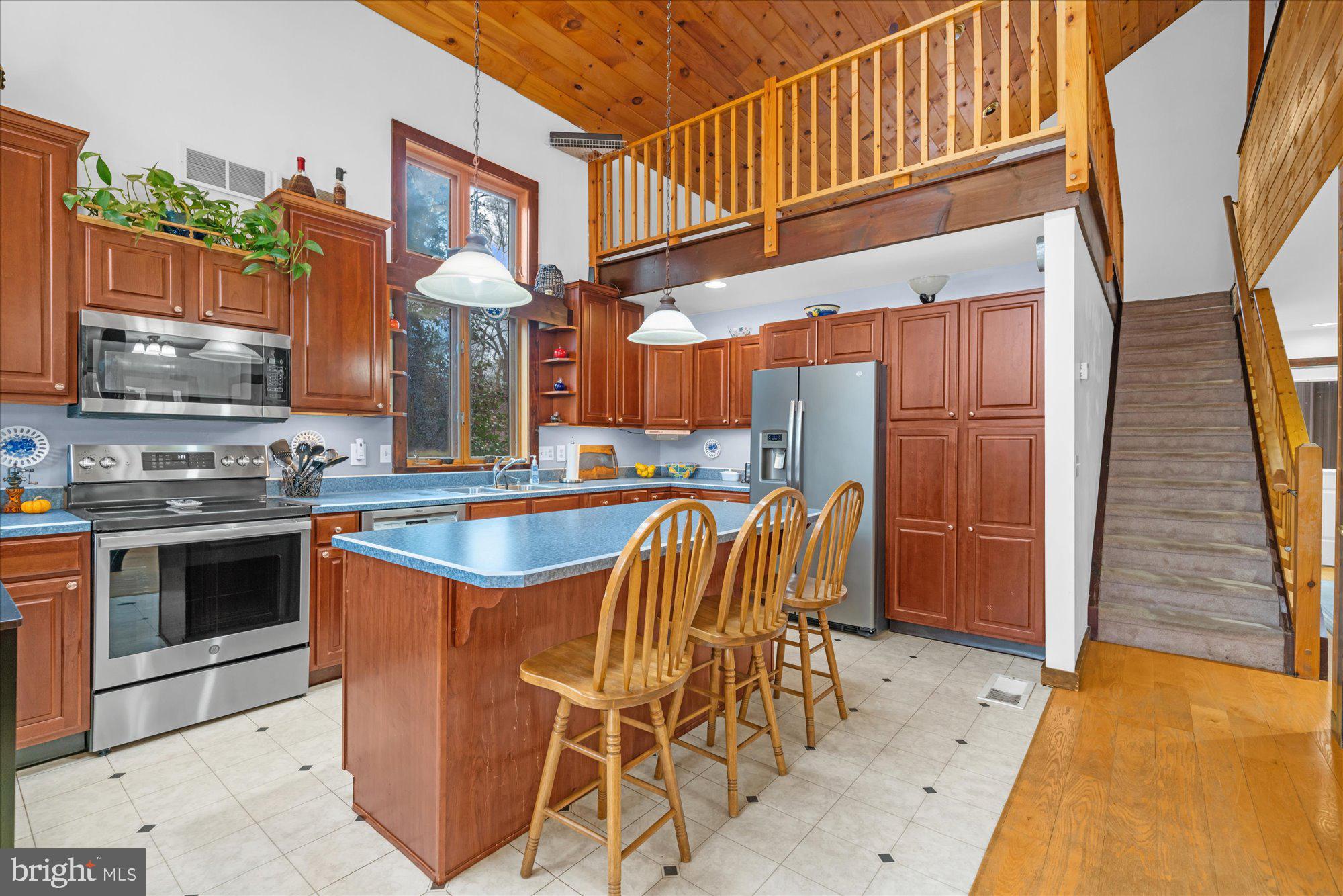 28 Highview Lane Mertztown, PA 19539 - Photo 8 of 57 a kitchen with stainless steel appliances granite countertop a stove a sink and a refrigerator
