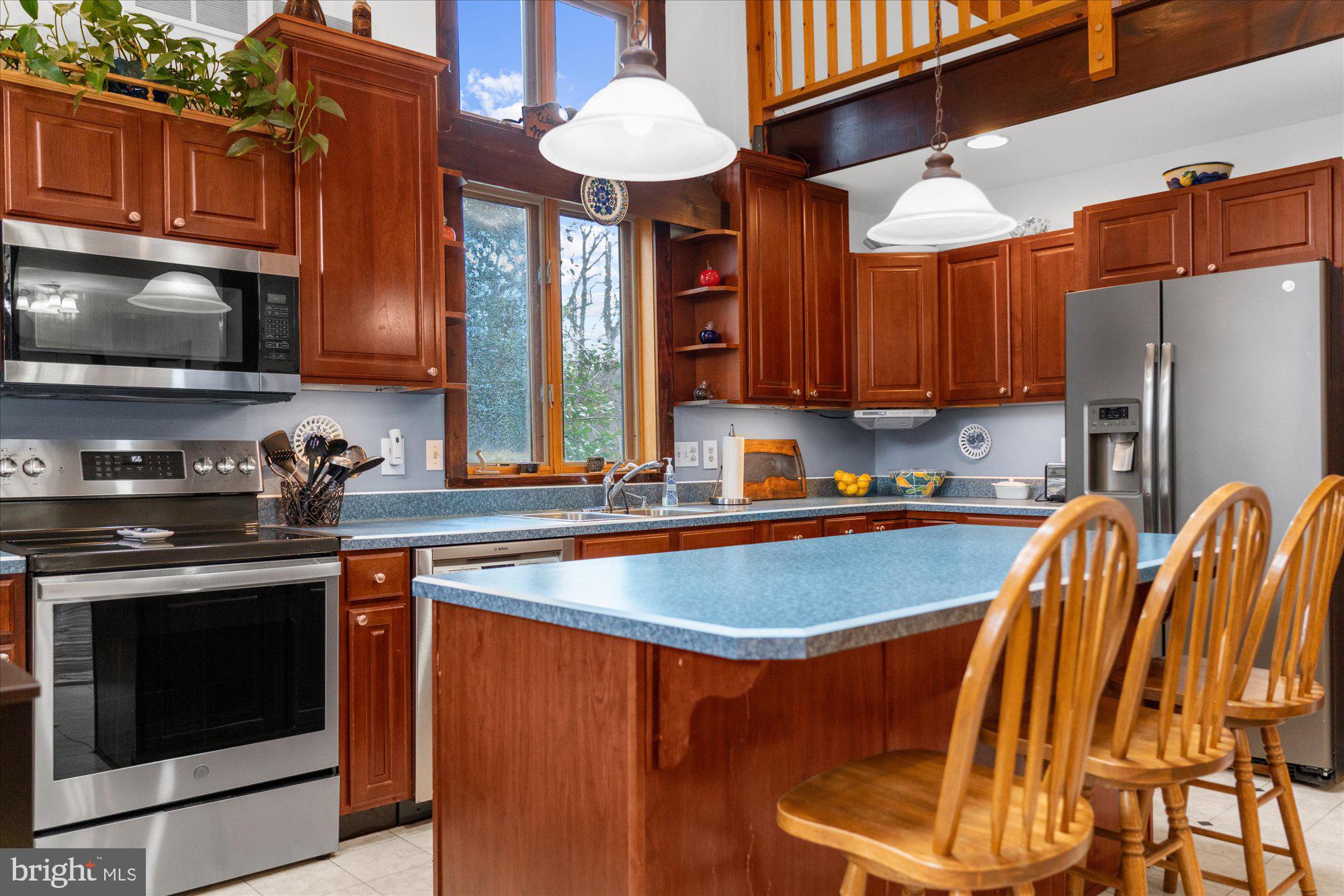 28 Highview Lane Mertztown, PA 19539 - Photo 9 of 57 a kitchen with stainless steel appliances granite countertop a sink stove and refrigerator