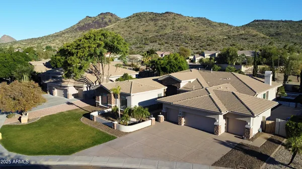 an aerial view of a house with a yard