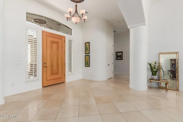 a view of a dining room with furniture and chandelier
