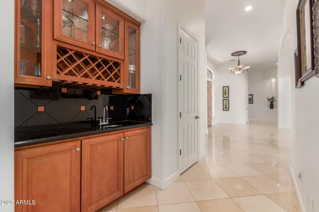 a living room with furniture a fireplace and a large window
