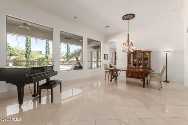 a living room with furniture kitchen view and a large window