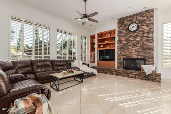 a large kitchen with kitchen island granite countertop a stove a sink a dining table and chairs