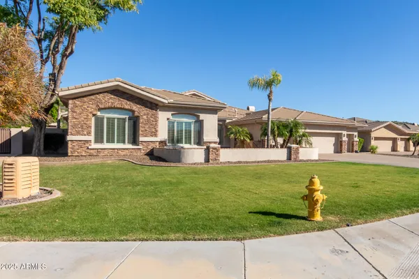 a view of a livingroom with a chandelier curtains and large windows