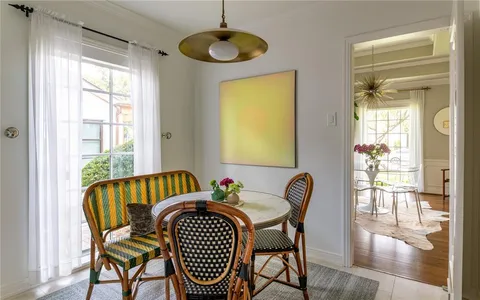 a view of a dining room with furniture wooden floor and a chandelier
