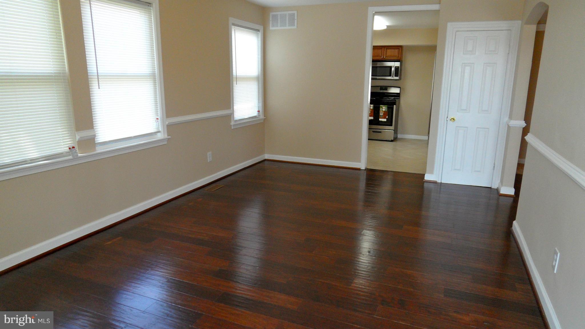 3604 Florida Road Baltimore, MD 21244 - Photo 3 of 28 an empty room with wooden floor and windows