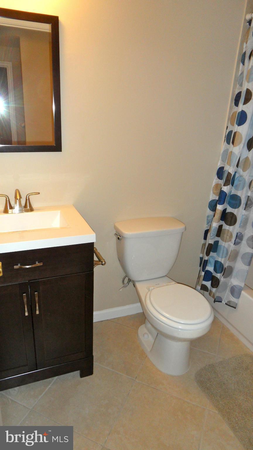 3604 Florida Road Baltimore, MD 21244 - Photo 23 of 28 a bathroom with a toilet a sink and mirror