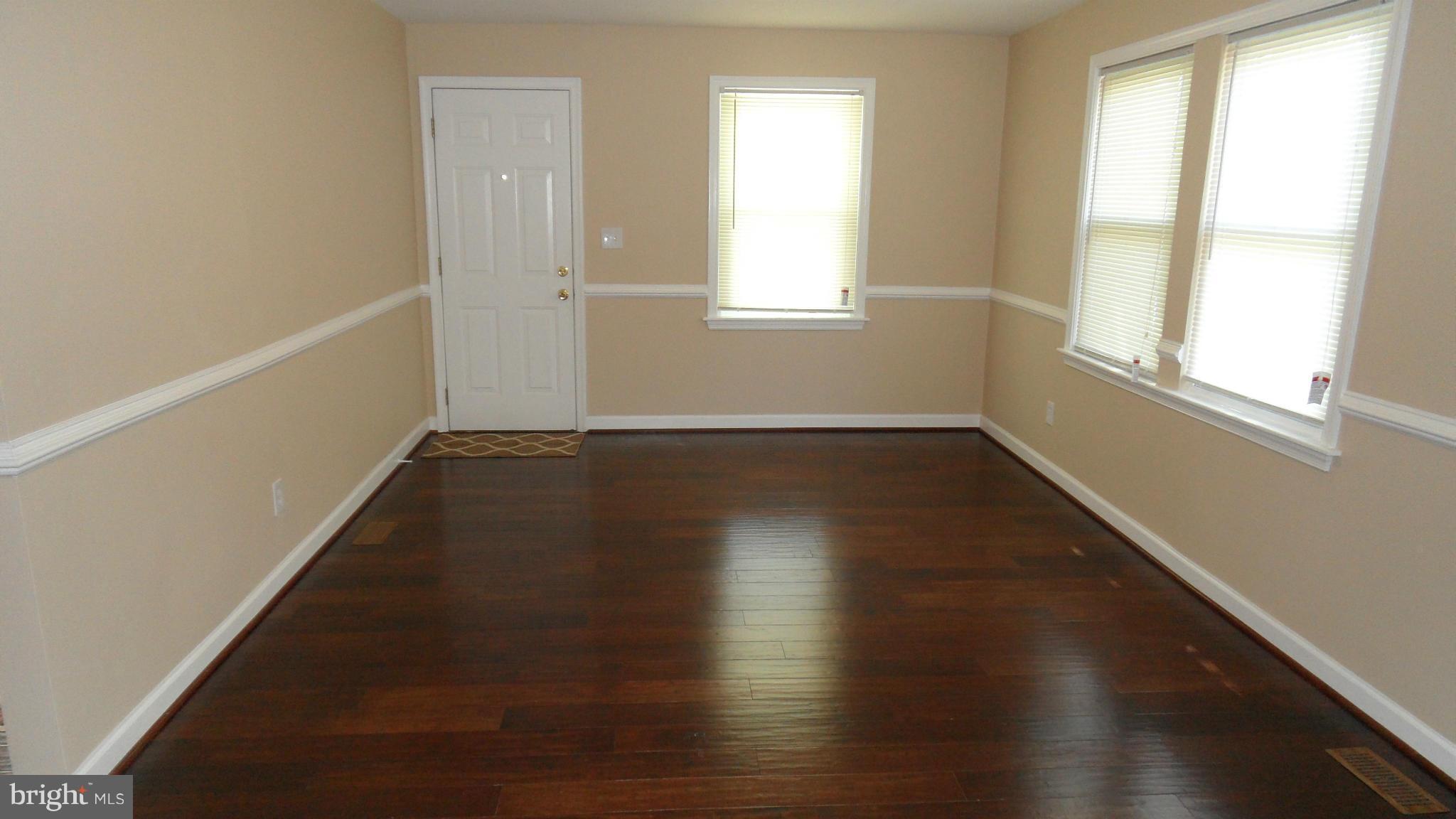 3604 Florida Road Baltimore, MD 21244 - Photo 4 of 28 an empty room with wooden floor and windows