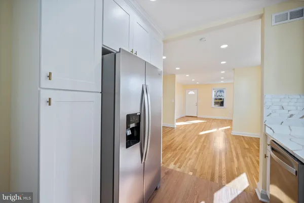a view of hallway with wooden floor