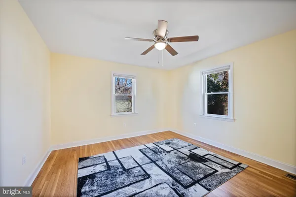 a view of a room with wooden floor and staircase