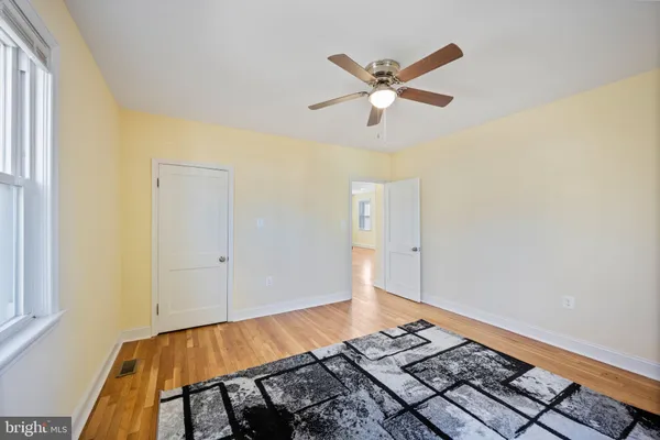 a view of a room with wooden floor and staircase