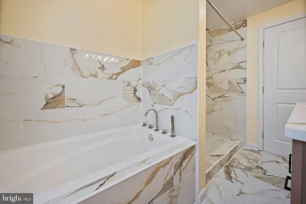 a bathroom with a bathtub and shower