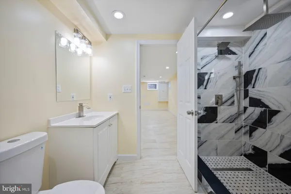 a bathroom with a sink toilet and shower
