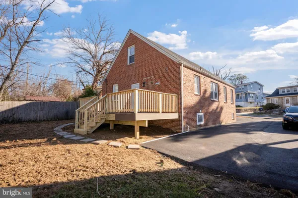 a front view of a house with a yard covered in snow