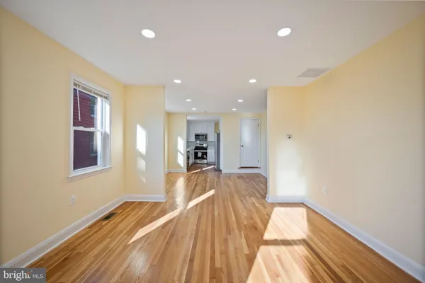 a view of a bedroom with wooden floor