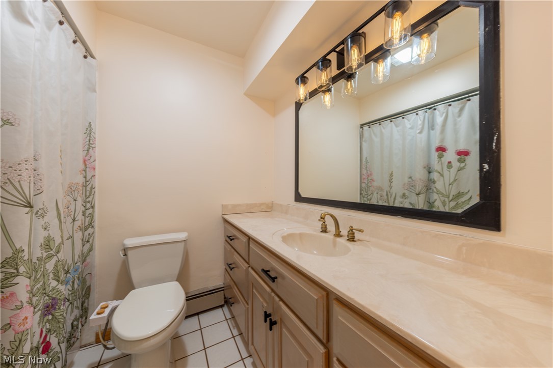 7969 Dines Road Novelty, OH 44072 - Photo 31 of 48 Bathroom featuring a wide vanity with an integrated sink, a large framed mirror, and a multi-bulb vanity light fixture