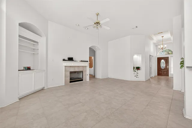 a view of a livingroom with a fireplace and window