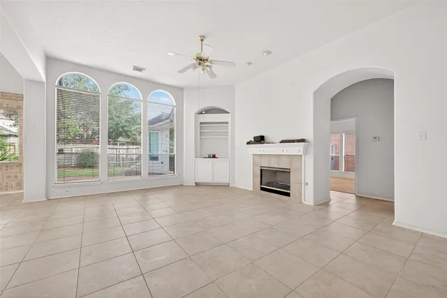 a view of an empty room with a fireplace and a window