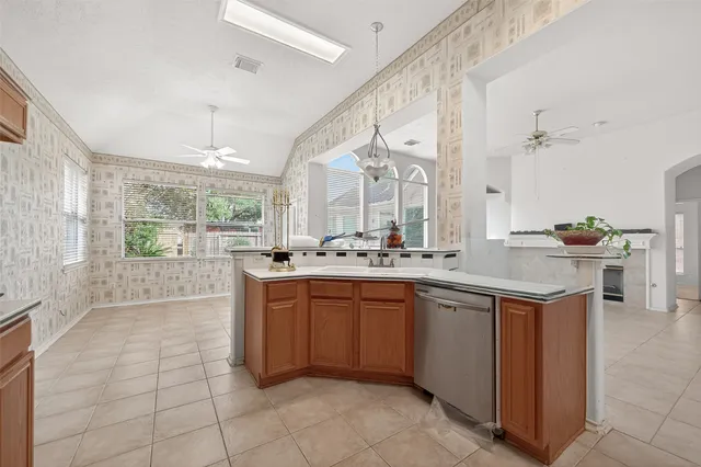 a large kitchen with kitchen island a sink stainless steel appliances and cabinets